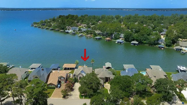 a backyard of a house with wooden floor and lake view