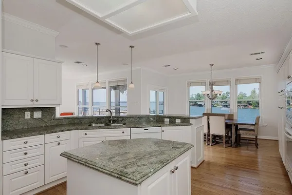 a kitchen with stainless steel appliances granite countertop a sink stove and cabinets