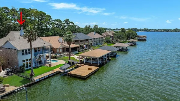 an aerial view of a house with swimming pool garden view and lake view