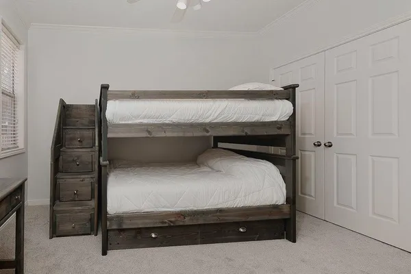 a bedroom with a bed and cabinet