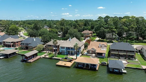 a aerial view of a house with swimming pool and lake view