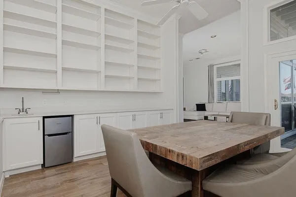 a view of a kitchen area with furniture and wooden floor