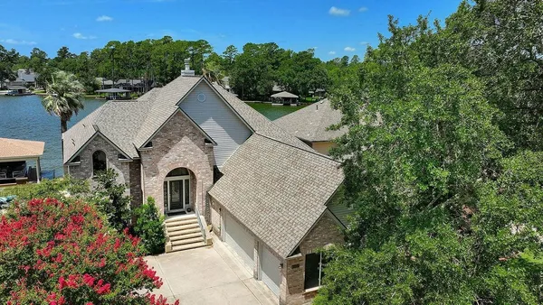 an aerial view of a house with outdoor space lake view and lake view