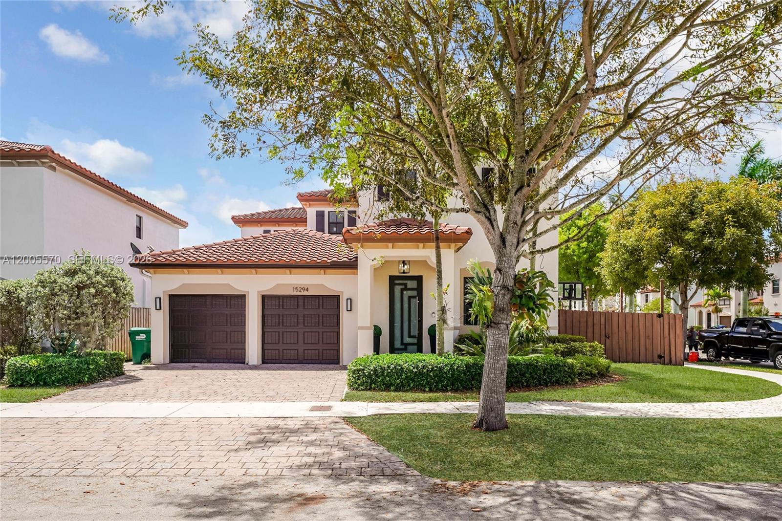 15294 Southwest 173rd Street Miami, FL 33187 - Photo 1 of 48 a front view of a house with garden