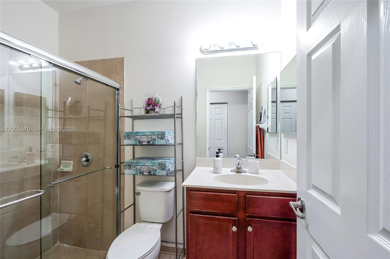 15294 Southwest 173rd Street Miami, FL 33187 - Photo 13 of 48 a bathroom with a sink toilet and shower