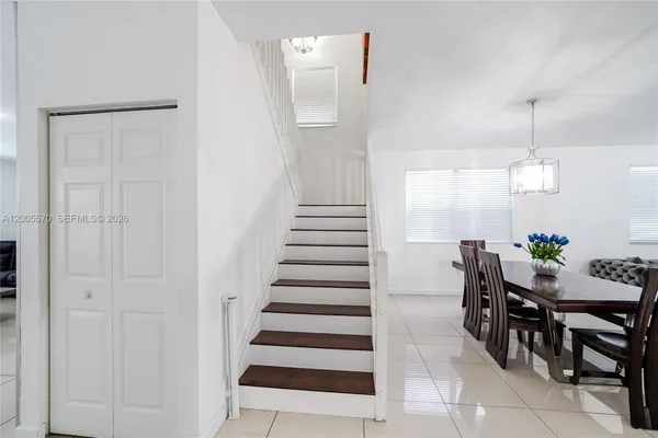 a kitchen with stainless steel appliances kitchen island granite countertop a refrigerator and a stove top oven