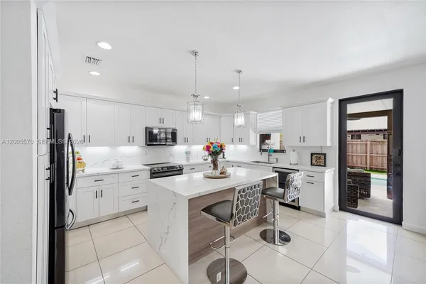 a kitchen with a sink and refrigerator