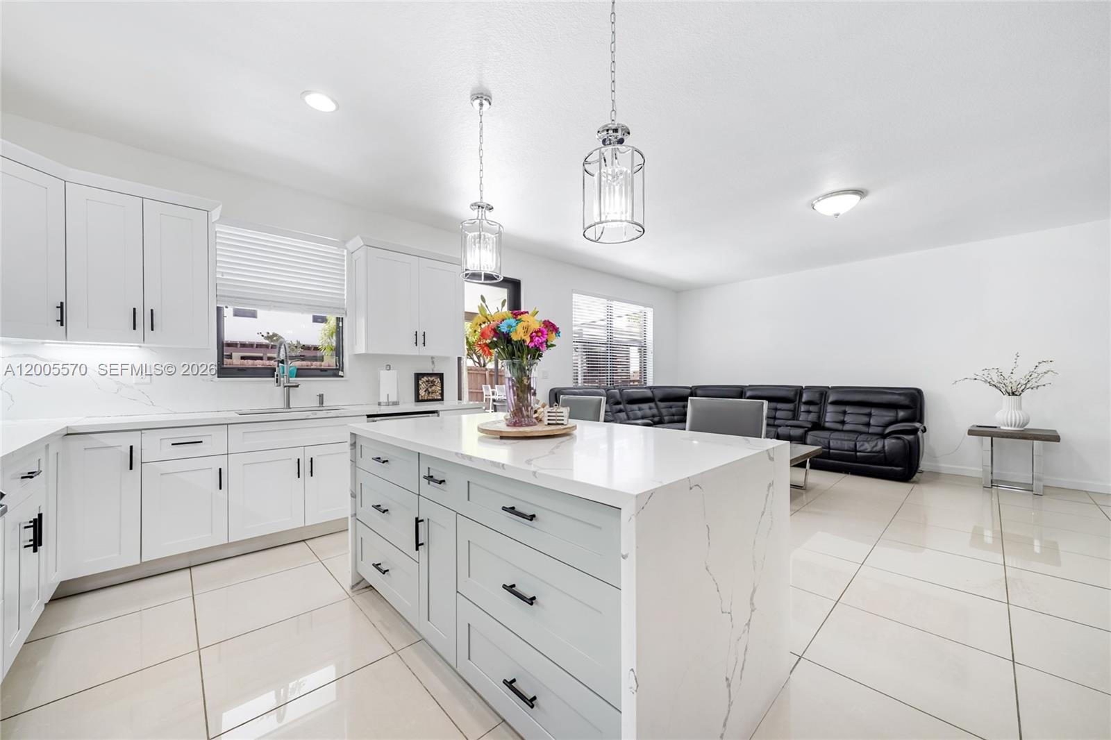 15294 Southwest 173rd Street Miami, FL 33187 - Photo 18 of 48 a kitchen with a sink dishwasher and white cabinets with wooden floor
