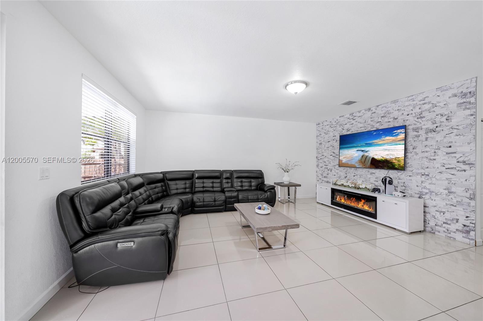 15294 Southwest 173rd Street Miami, FL 33187 - Photo 20 of 48 a living room with furniture and a flat screen tv