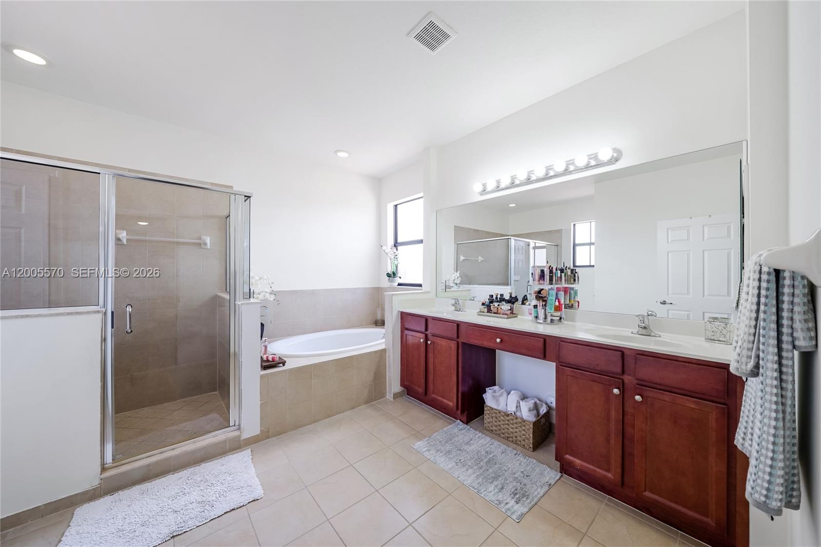15294 Southwest 173rd Street Miami, FL 33187 - Photo 24 of 48 a spacious bathroom with a bathtub shower sink double and mirror