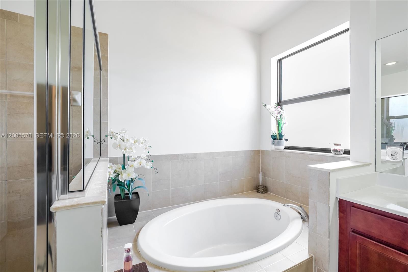 15294 Southwest 173rd Street Miami, FL 33187 - Photo 26 of 48 a bathroom with a sink and a window