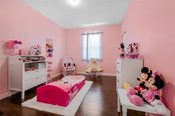 a spacious bathroom with a double vanity sink a toilet and a mirror