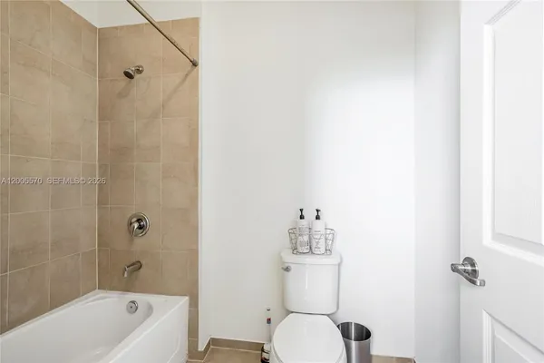 a bedroom with a bed and a mirror