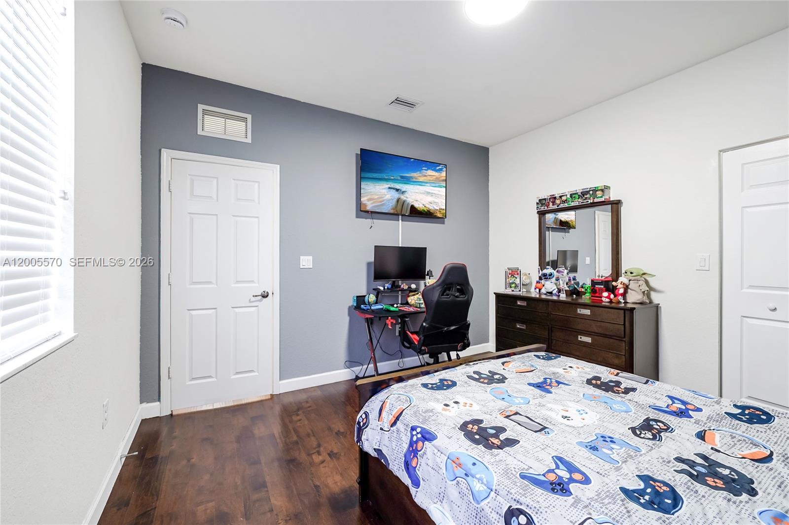 15294 Southwest 173rd Street Miami, FL 33187 - Photo 30 of 48 a bedroom with a bed and a mirror