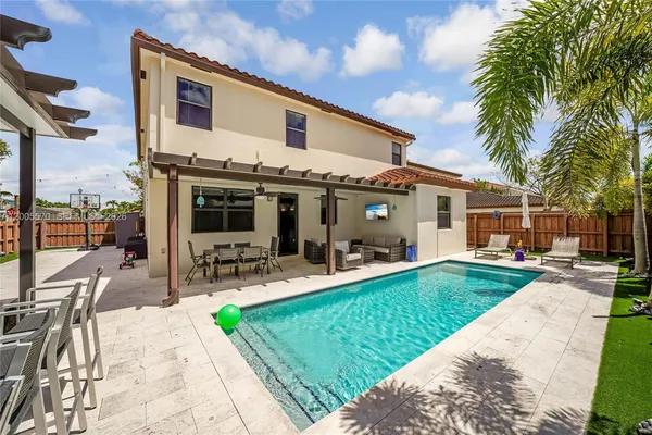 swimming pool view with a outdoor seating