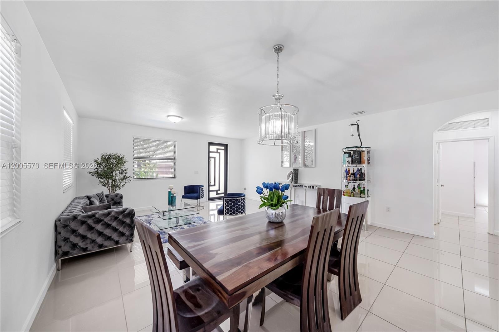 15294 Southwest 173rd Street Miami, FL 33187 - Photo 4 of 48 a view of a dining room with furniture and chandelier
