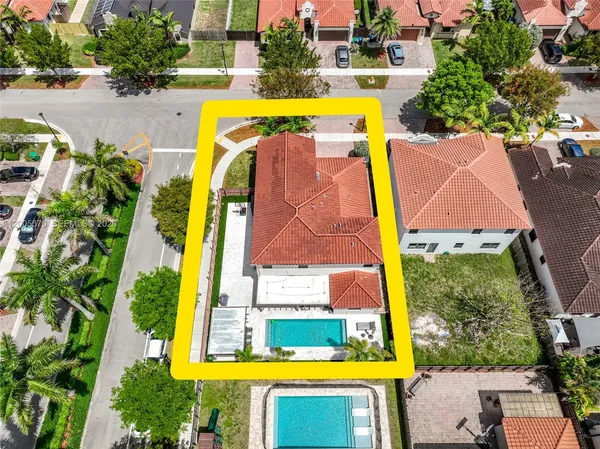 an aerial view of a house with swimming pool