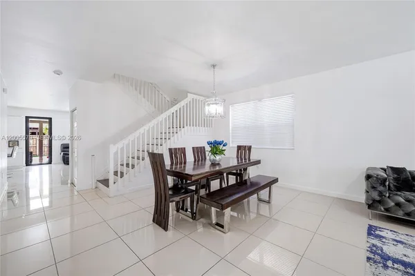 a dining room with furniture and wooden floor
