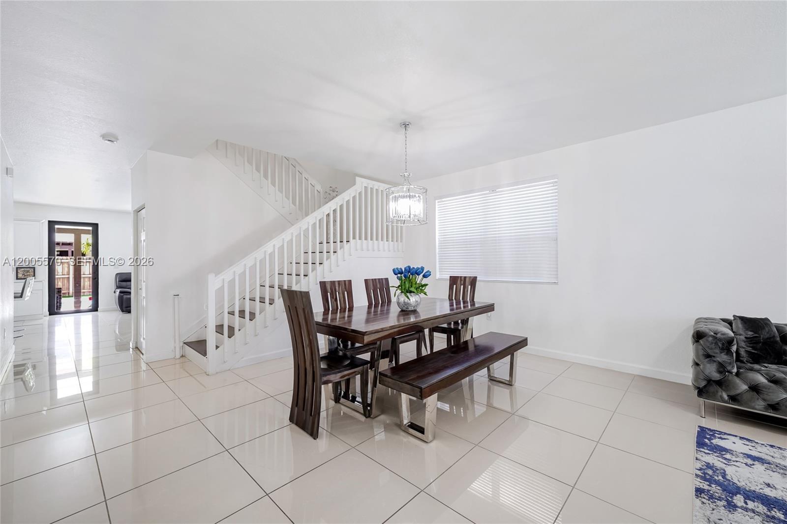 15294 Southwest 173rd Street Miami, FL 33187 - Photo 5 of 48 a dining room with furniture and wooden floor