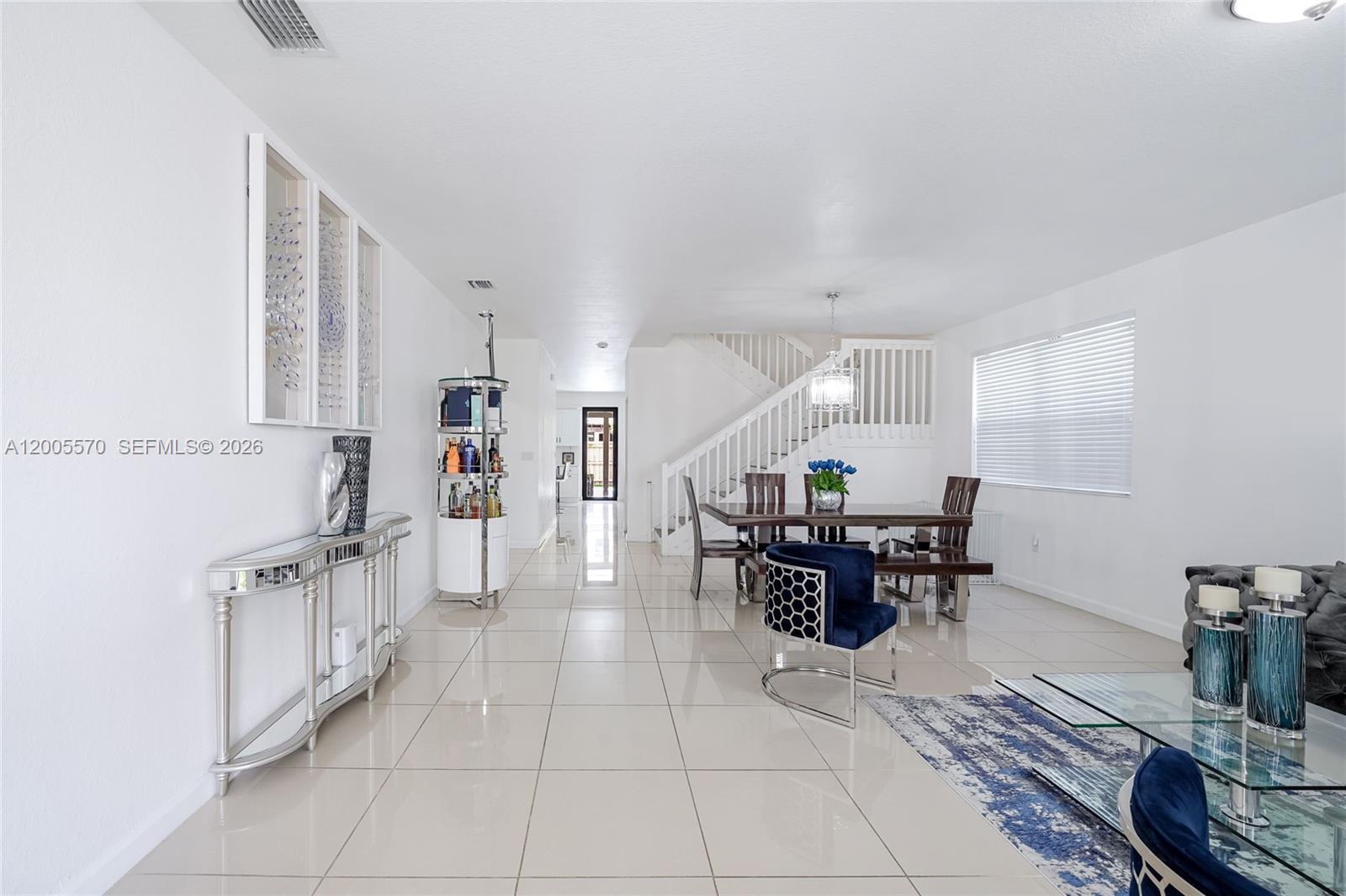 15294 Southwest 173rd Street Miami, FL 33187 - Photo 6 of 48 a dining hall with couches a coffee table and chairs with a dining table