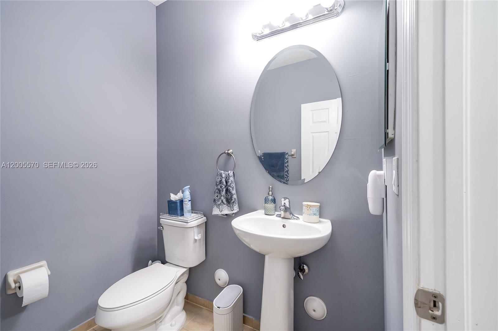 15294 Southwest 173rd Street Miami, FL 33187 - Photo 8 of 48 a bathroom with a toilet sink and mirror