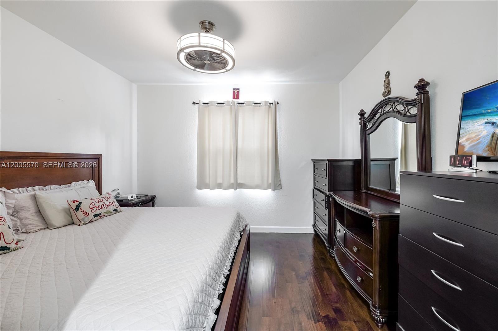 15294 Southwest 173rd Street Miami, FL 33187 - Photo 9 of 48 a bedroom with a bed and a chandelier