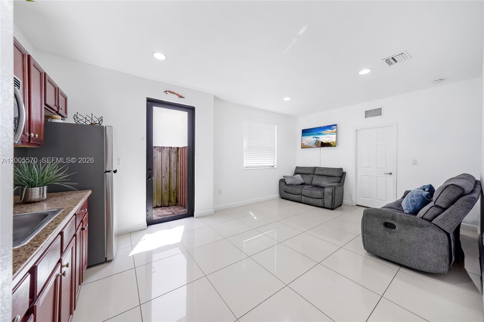 15294 Southwest 173rd Street Miami, FL 33187 - Photo 10 of 48 a kitchen with furniture a refrigerator and a sink