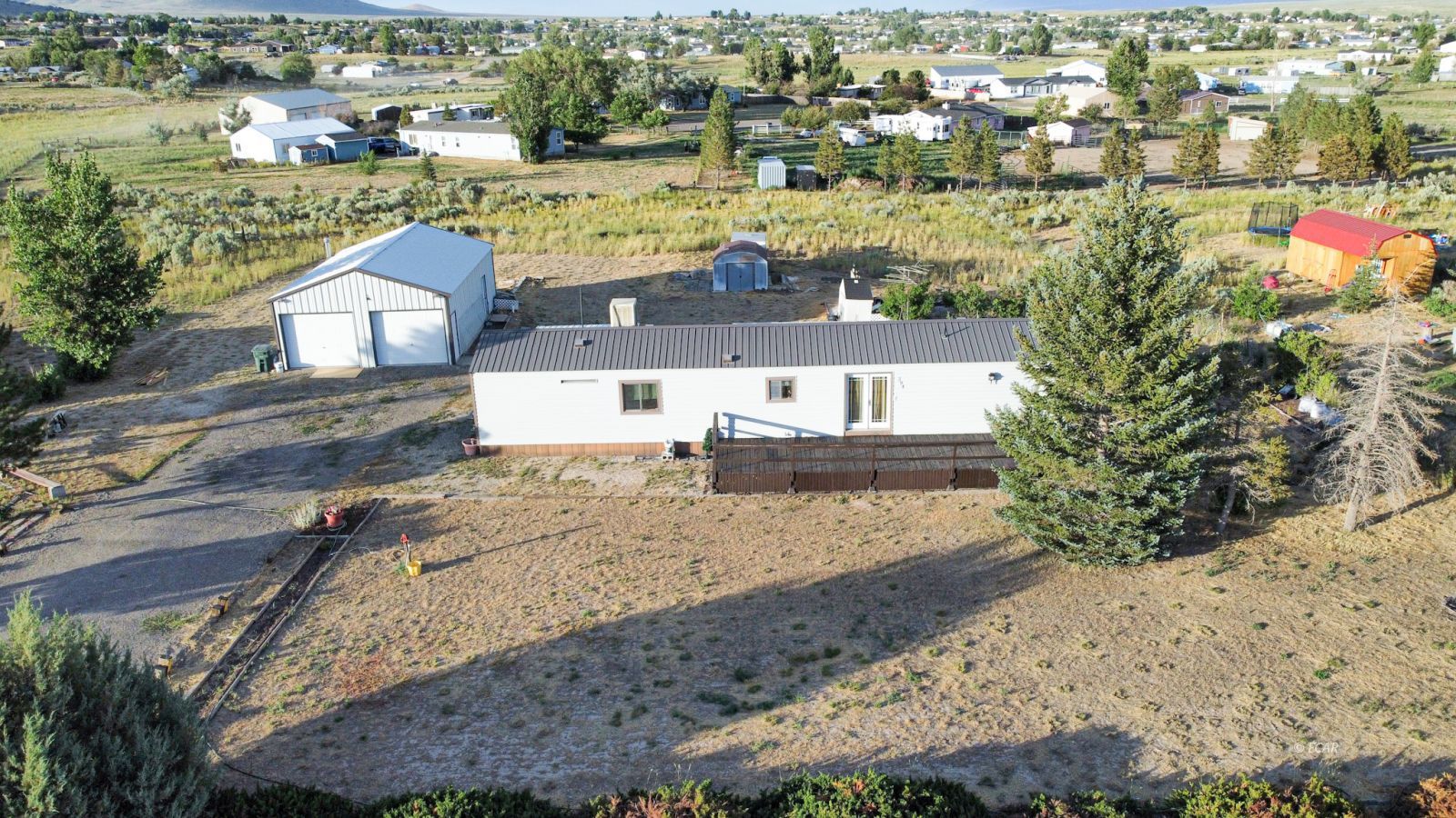 394 Spring Valley Parkway Spring Creek, NV 89815 - Photo 1 of 21 an aerial view of residential houses with outdoor space