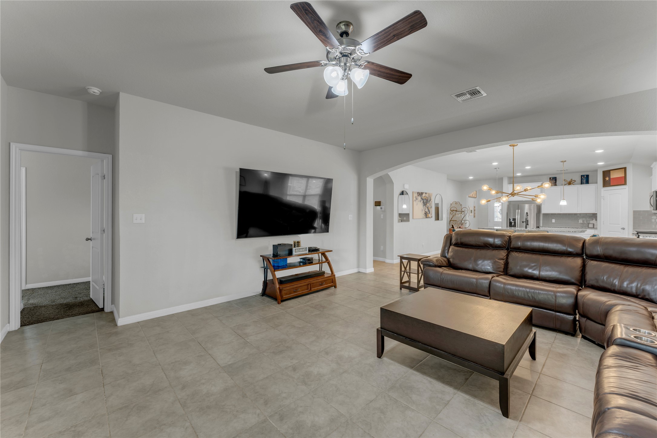 132 Cinnamon Loop Burnet, TX 78611 - Photo 10 of 27 Spacious living area featuring tile flooring, neutral wall tones, and a ceiling fan with light fixture