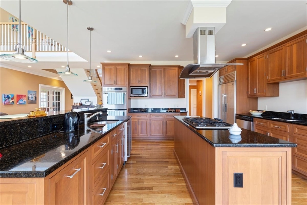 8 Middleby Road Lexington, MA 02421 - Photo 14 of 42 a kitchen with kitchen island granite countertop a sink a counter top space appliances and cabinets