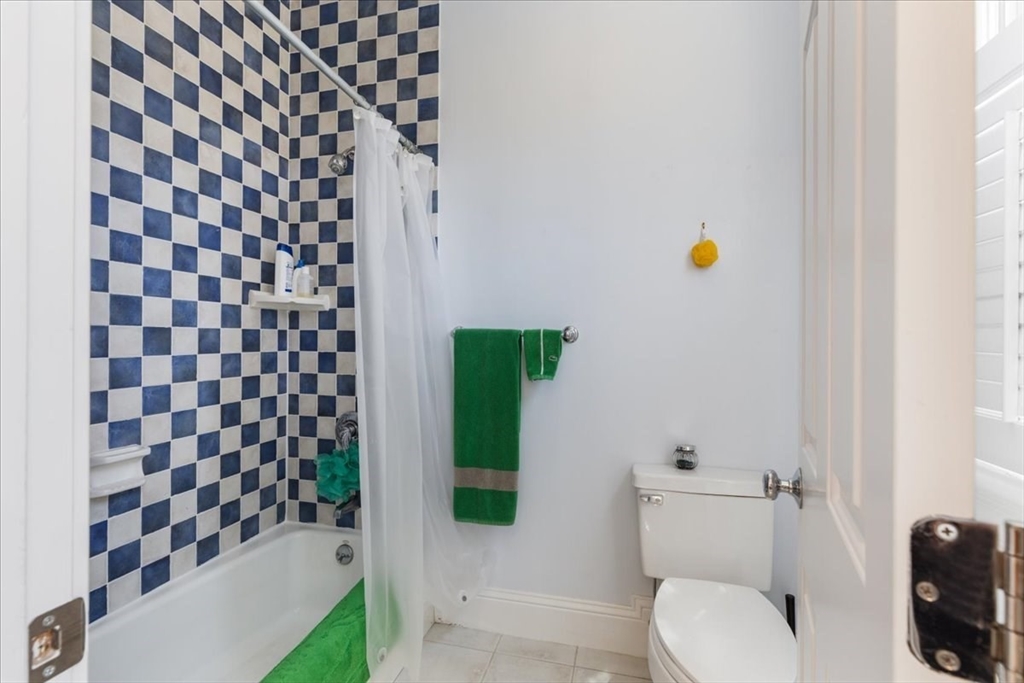 8 Middleby Road Lexington, MA 02421 - Photo 31 of 42 a bathroom with a toilet and a shower curtain