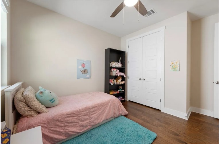 344 Pisa Lane Georgetown, TX 78628 - Photo 28 of 39 Rich hardwood flooring pairs with crisp white trim in this cozy secondary bedroom.
