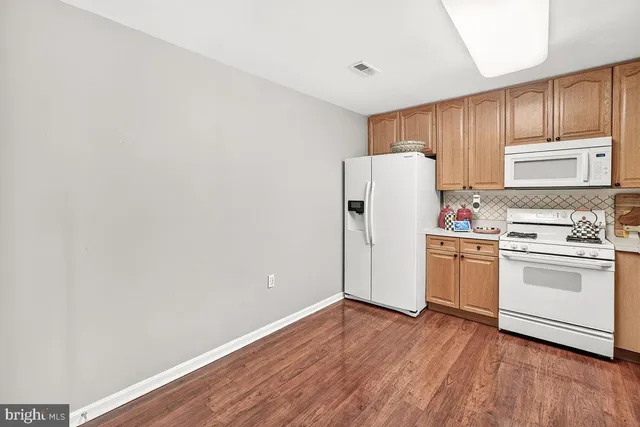 a view of a kitchen with stove and refrigerator
