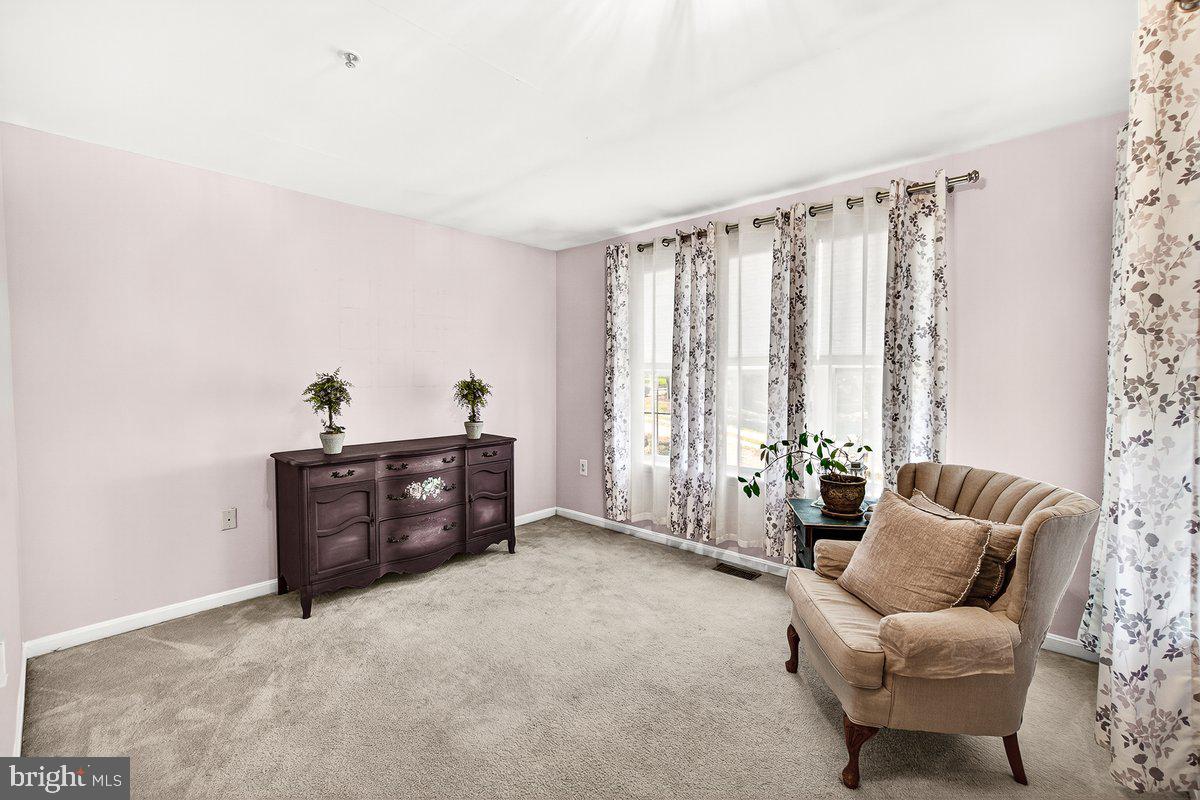 2663 South Everly Drive, Unit 75 Frederick, MD 21701 - Photo 20 of 39 a living room with furniture and a large window