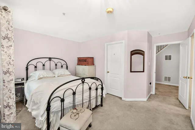 a bedroom with a bed and a sink