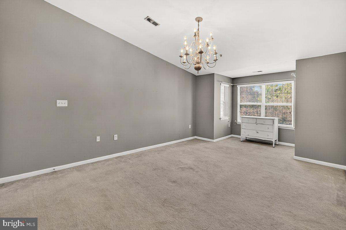 2663 South Everly Drive, Unit 75 Frederick, MD 21701 - Photo 26 of 39 an empty room with a chandelier