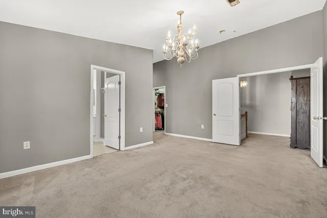 a view of a chandelier in big room and chandelier