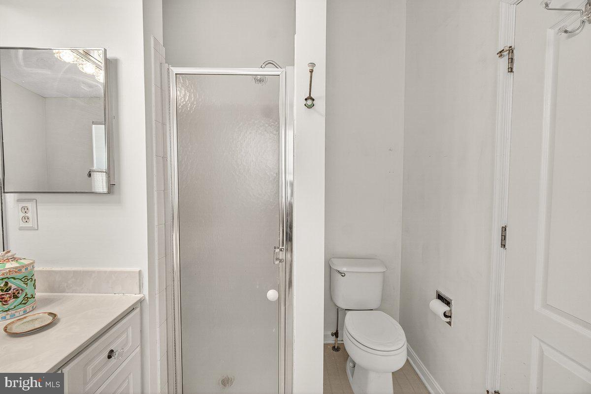 2663 South Everly Drive, Unit 75 Frederick, MD 21701 - Photo 29 of 39 a bathroom with a granite countertop sink toilet and shower