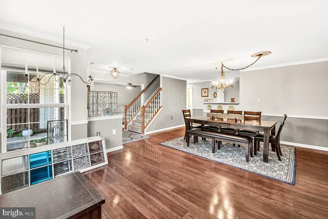 a living room with furniture a rug and wooden floor