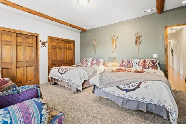 a living room with furniture floor to ceiling window and a flat screen tv