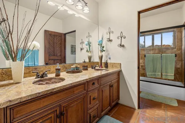 a bedroom with a bed and a mirror