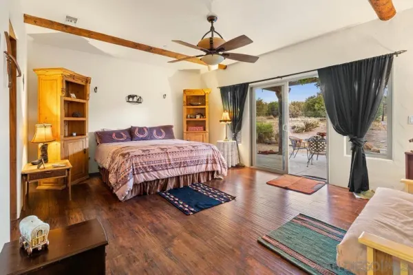 a view of a balcony with chairs and a potted plant