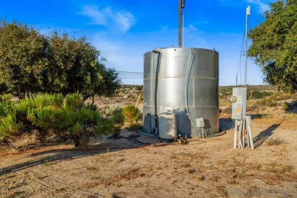 a kitchen with stainless steel appliances kitchen island granite countertop a table and chairs in it