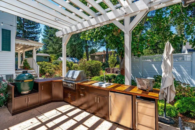 a view of a patio with chairs and potted plants