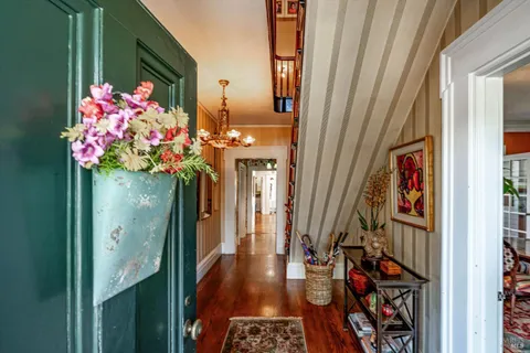 a dining room with furniture a large window and a chandelier