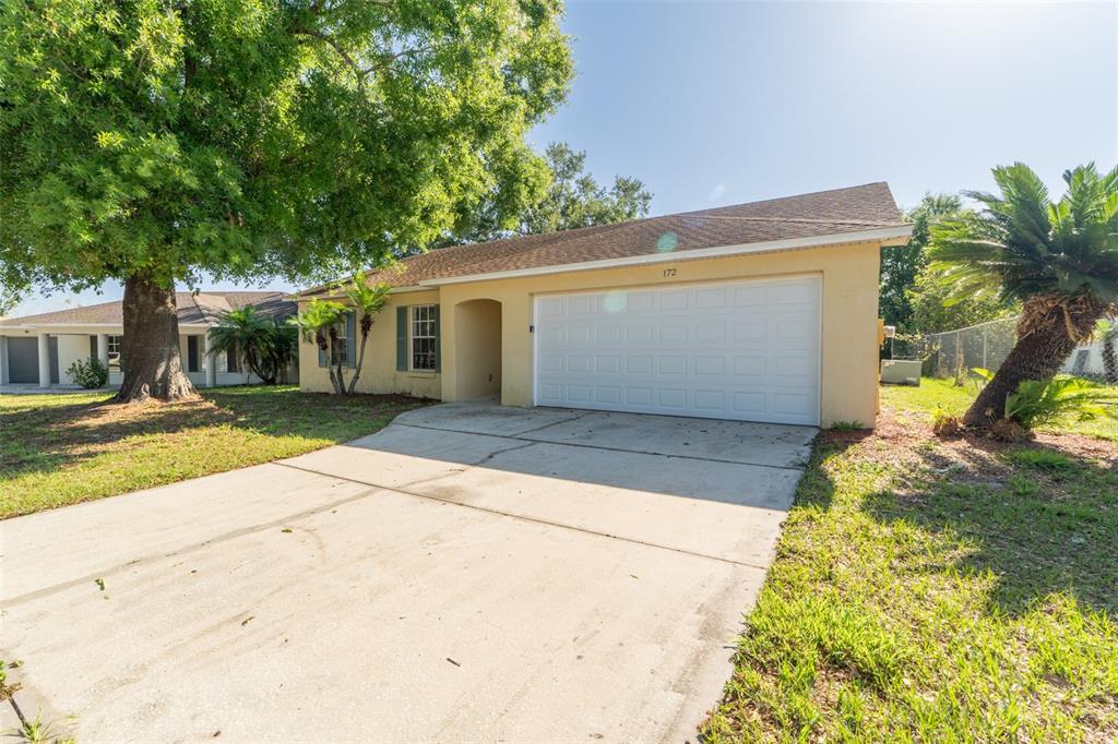 172 Diamond Ridge Boulevard Auburndale, FL 33823 - Photo 1 of 1 a front view of a house with a yard and potted plants