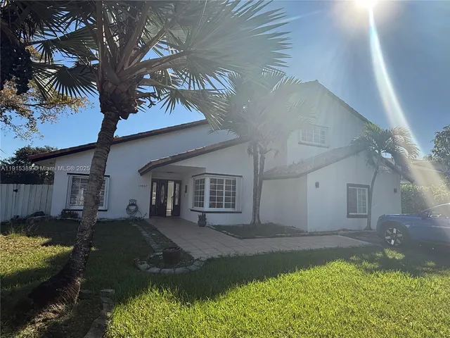 a backyard of a house with yard fire pit table and chairs