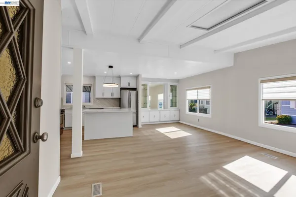 a kitchen with stainless steel appliances granite countertop a sink a stove and a refrigerator