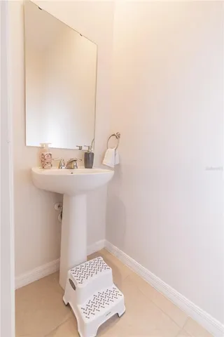 a bathroom with a sink a mirror and a window