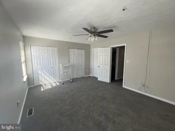 a view of empty room with ceiling fan